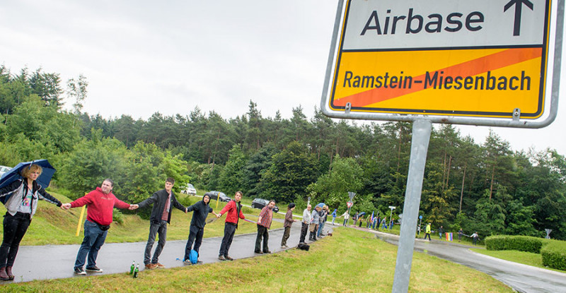 Activists attend a rally "Stop-Ramstein" on the road leading to US Air Force Base in Ramstein-Miesenbach on June 11, 2016. © Oliver Dietze / DPA / AFP